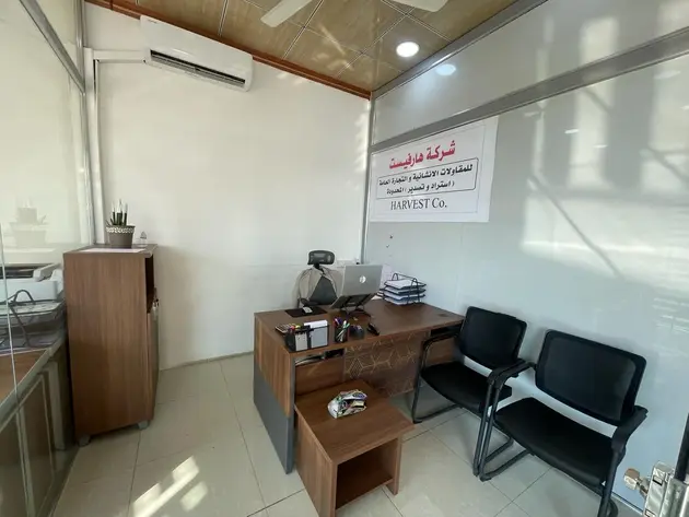 Harvest Co. office interior, featuring a workspace with a desk and chairs.